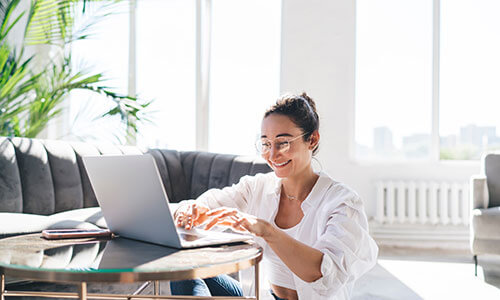 Laptop user enjoying quick indexing with automated batch processing in a bright room.